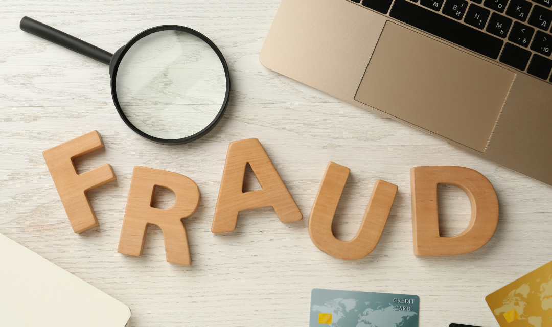 Wooden letters spelling fraud