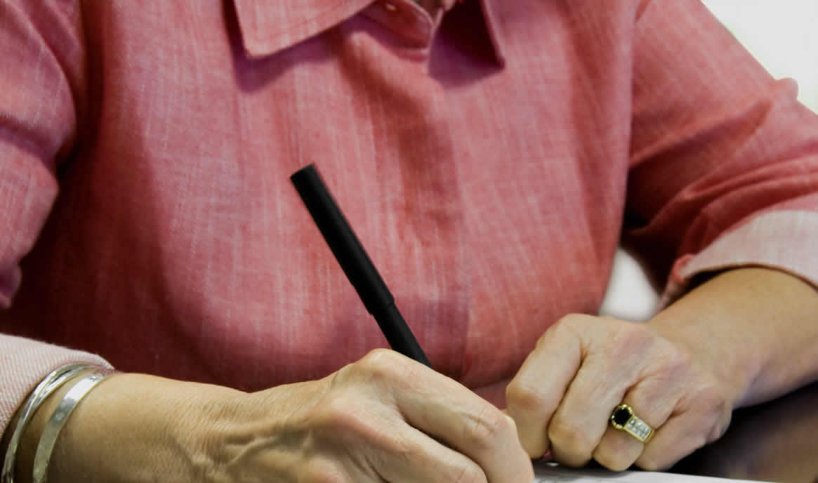 woman signing documents